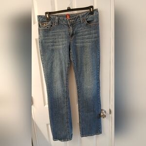 Sasson Jeans – Size 12, Medium Wash Denim with Logo Hardware & Flip‑Tab Pocket